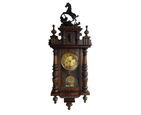 A German spring driven wall clock c1900 in a compact mahogany veneered Vienna style case, with a full-length glazed door and 