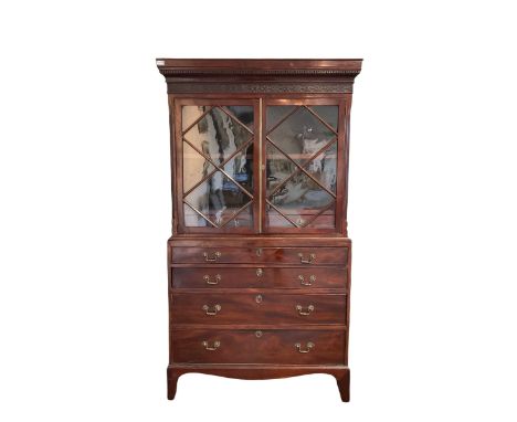 19th century mahogany bookcase on chest, the projecting dentil cornice and carved frieze over two glazed doors of astragal de