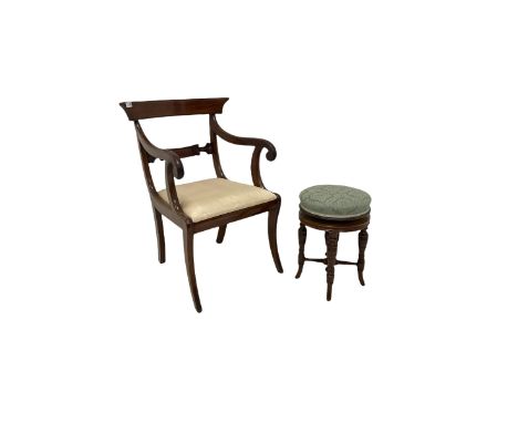 Mahogany regency style carver chair, the shaped cresting rail over scrolled arms and drop in seat pad, raised on sabre suppor