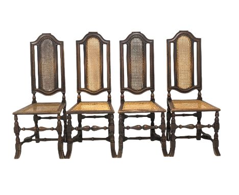 Set of four Victorian oak high back hall chairs of an earlier design, shaped crest rail over cane back and seat panel, raised
