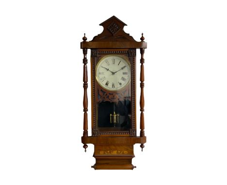 A 19th century American wall clock manufactured by the �New Haven�  clock company, in a mahogany case with an architectural p