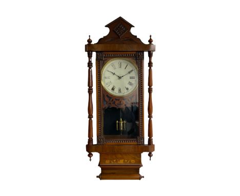 A 19th century American wall clock manufactured by the �New Haven�  clock company, in a mahogany case with an architectural p