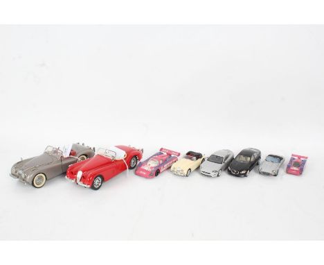 A Burago Jaguar XK 120 1/24 scale in red, The Danbury Mint 1949 Jaguar XK 120 1/24 scale in off silver, together with siz 1/4