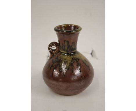 John Leach for Muchelney Pottery, a squat vase with tapering neck, loop handle and bulbous body, the exterior with mottled gl