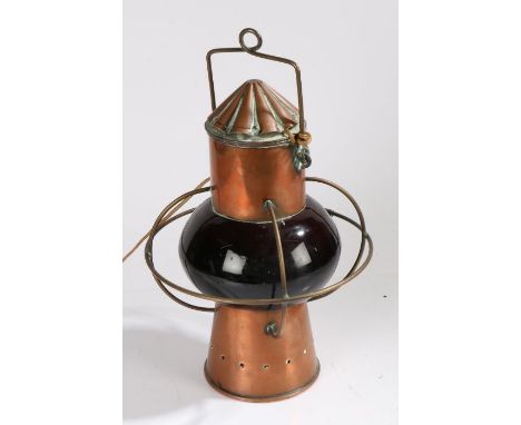 20th century copper ships lamp, with a copper funnel design top above a bulbous red glass body 43cm high&nbsp;