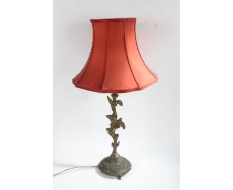 Cast brass table lamp, with floral column and circular base decorated with swags, raised on three feet, 64cm tall including f