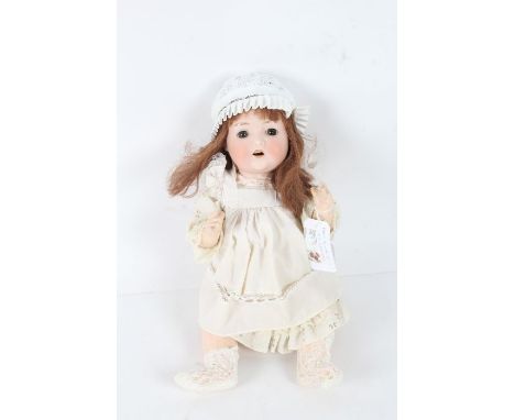 Paul Schmidt bisque headed doll, with long brown hair and white dress, 38cm long