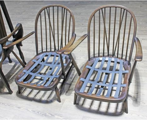 A pair of Ercol dark beech lounge chairs.  