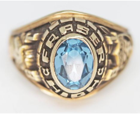 An American 10ct gold high school graduation ring set with an aquamarine coloured stone, gross wt. 6g, size M.  