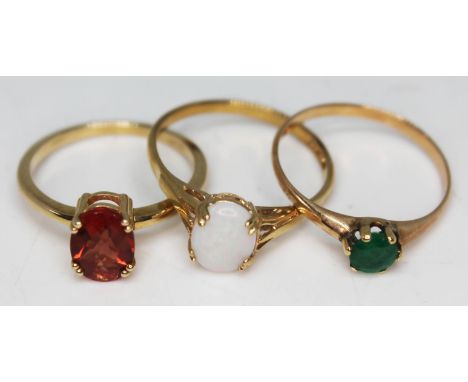 A group of three 9ct gold single stone rings, stones comprising andesine, opal and emerald, various marks, gross wt. 4.4g, si