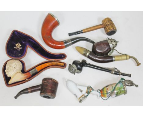 A mixed lot of pipes comprising a carved meerschaum Lord Kitchener pipe with pressed butterscotch amber mouthpiece and origin