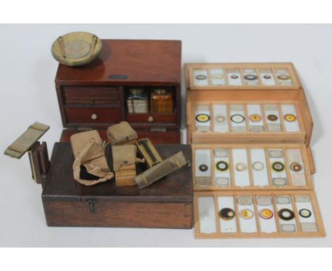 Microscope accessories comprising a slide maker with ringing table, bottles and slide drawers, the top labelled 'The Microsco