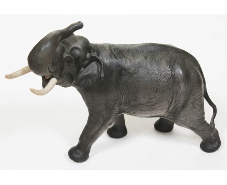 A large Beswick elephant with trunk in salute, length 42cm.  Condition - good, no chips, cracks nor any restoration, minor we