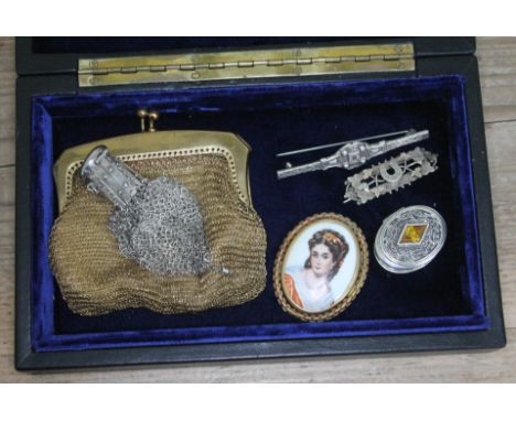 A mixed box of items to include two hallmarked silver brooches, a silver pill box, a Limoges porcelain portrait brooch and tw
