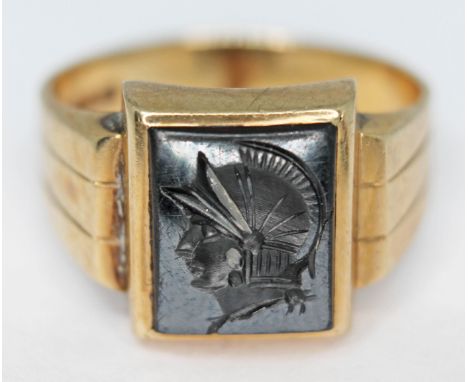 A yellow metal hematite intaglio ring, indistinctly marked '10K', gross wt. 5.9g, size R.  