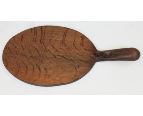 A Robert "Mouseman" Thompson of Kiburn English oak cheese board with carved mouse signature to handle, length 37.5cm.  