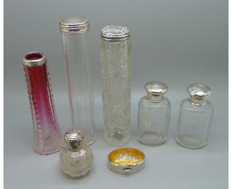 Four silver topped bottles, a silver topped scent bottle, a silver mounted vase and a silver and enamel trinket box marked 's