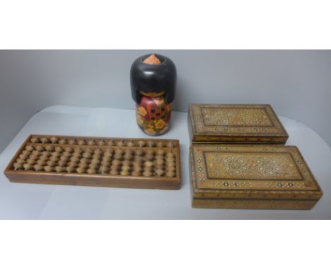 Two Syrian wooden cigar boxes with decorative inlay, a Japanese 15-bar abacus and a wooden Geisha figure 