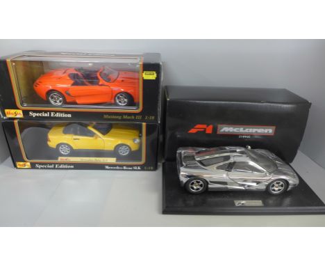 Three 1:18th scale die-cast model vehicles, 2x Maisto and a McLaren 1993, all boxed 