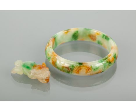 CHINESE CARVED JADE BANGLE AND A CARVED JADE PENDANT the bangle carved with a floral design, the pendant carved in the form o