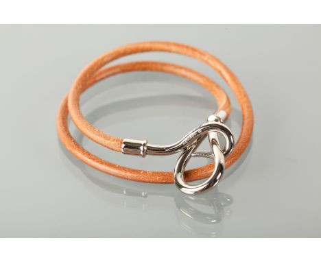 HERMES LEATHER BRACELET in tan leather, the buckle with HERMES and mongram, in box