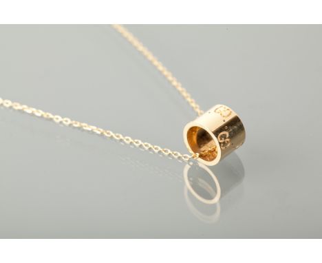 EIGHTEEN CARAT GOLD GUCCI PENDANT ON CHAIN of cylindrical form, with engraved G motifs and dotted lines, (R) GUCCI made in It