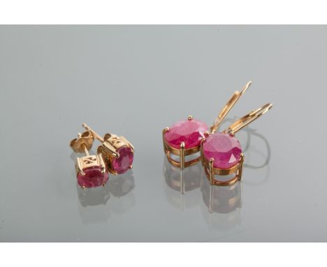 TWO PAIRS OF RUBY EARRINGS comprising a pair of studs with oval rubies 7mm long, marked 375 for nine carat gold and a pair of