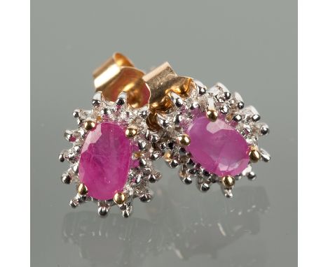PAIR OF RUBY AND DIAMOND CLUSTER EARRINGS each set with an oval ruby surrounded by diamonds, unmarked, the backs marked 375 f
