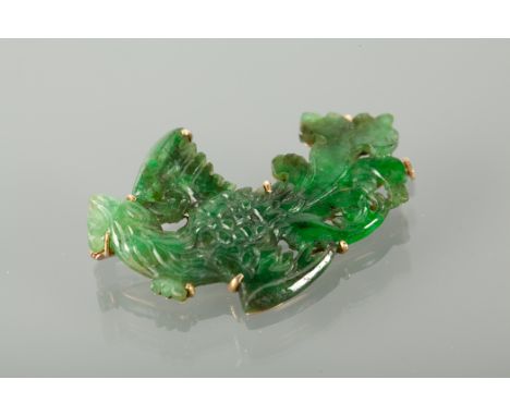 FINE CARVED JADE BROOCH carved in the form of a bird, with a pierced mount marked 14k for fourteen carat gold, 45mm across, n