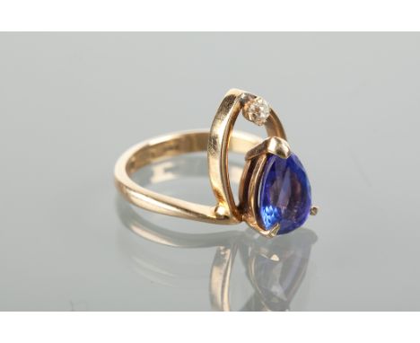 UNUSUAL MID-TWENTIETH CENTURY TANZANITE AND DIAMOND DRESS RING with a pear cut tanzanite and an old cut diamond, with a loop 