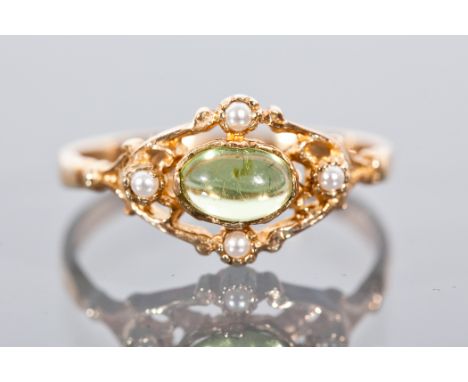 VICTORIAN STYLE PERIDOT AND SEED PEARL DRESS RING set with a central cabochon cut peridot, in a pierced setting with seed pea