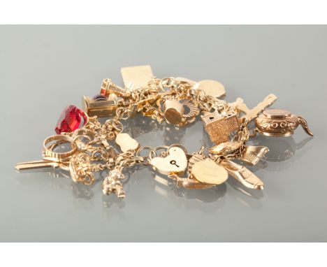 NINE CARAT GOLD CHARM BRACELET with charms including a church, a teapot and a windmill, 50g