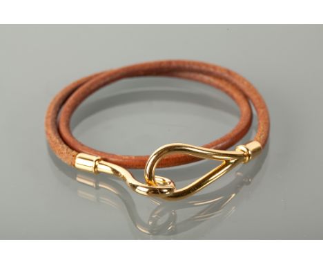 HERMES LEATHER BRACELET in brown leather, the buckle with HERMES and mongram, in box