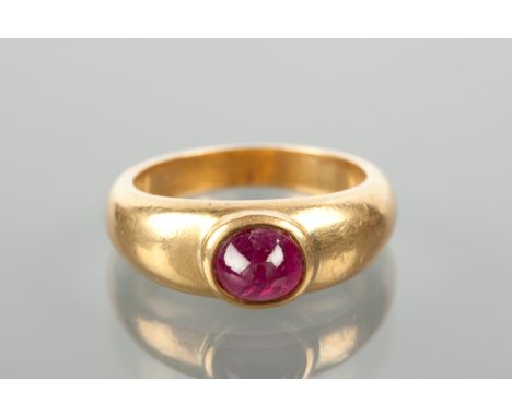 LATE TWENTIETH CENTURY RUBY RING set with a single oval cabochon cut ruby approximately 7.2mm across, in a broad band tapered