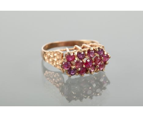 LATE TWENTIETH RUBY DRESS RING with three rows of round rubies, marked 375 for nine carat gold, size L