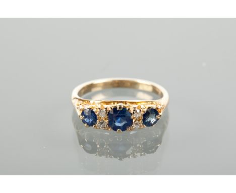 VICTORIAN SAPPHIRE AND DIAMOND RING set with three sapphires, interspersed with four diamonds, in a boat shaped setting, mark