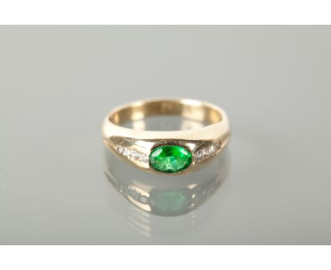 GREEN AND WHITE GEM SET RING set with a central oval cut green stone flanked by rows of white gems, unmarked, size R-S