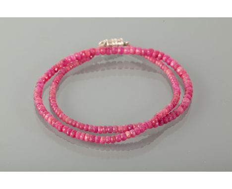 RUBY BEAD NECKLACE formed by graduated faceted ruby beads, the largest bead 4.6mm, the smallest bead 2.8mm, with a magnetic c