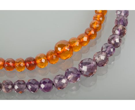 AMETHYST BEAD NECKLACE AND AN AMBER BEAD NECKLACE both with graduated faceted beads, both 43cm long