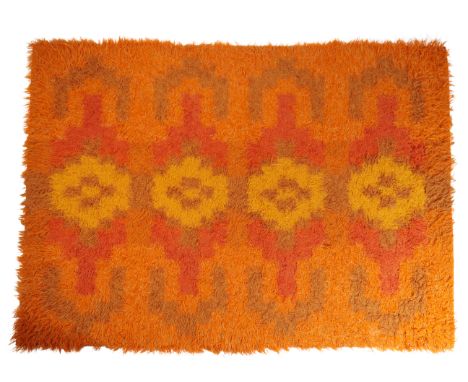 TABERGS YLLEFABRIKS AB, SWEDEN: A VINTAGE RUG (MATTA) with repeating geometric motif against a bright orange ground, 235cm x 