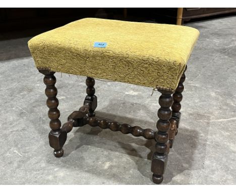A bobbin turned upholstered stool. 19½' wide