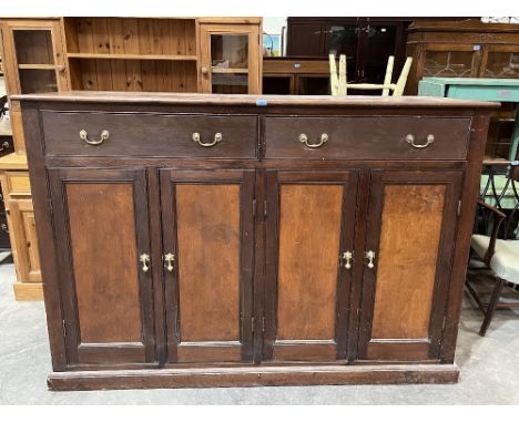 An early 20th century pine topped cupboard enclosed by four panel doors under a pair of frieze drawers, on plinth support. 74