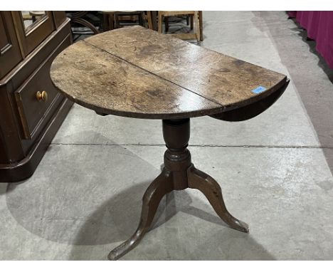 A Georgian oak dropleaf tripod table 31' diam. Loss to foot. Converted to a dropleaf at a later date