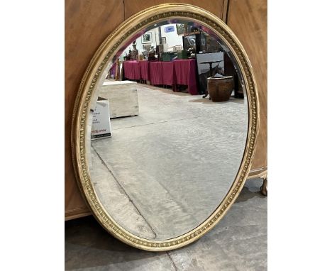 An early 20th century gilt framed oval mirror with bevelled plate. 44' x 34'