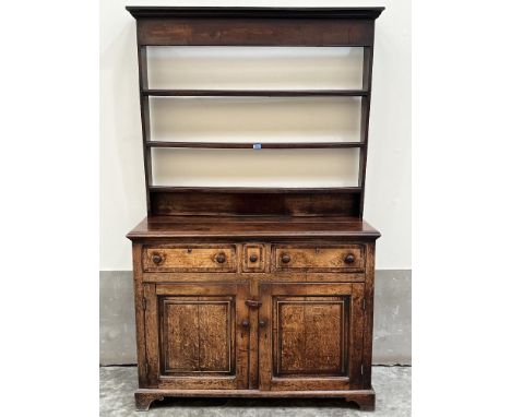 An 18th century dresser, the raised rack with three shelves, the base with three crossbanded and line inlaid drawers over a p