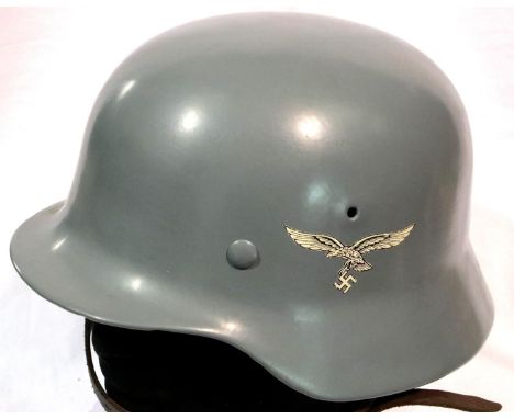 A German WWII replica Luftwaffe helmet with leather liner and chin strap, size 56. P&amp;P Group 2 (£18+VAT for the first lot