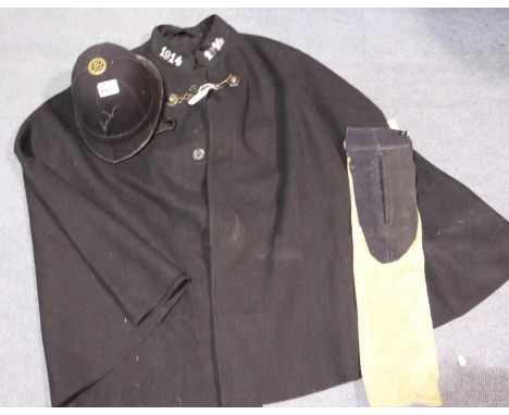 A 20th century Police cape with lion mask clasp, numbered 1914, together with an unbadged helmet. P&amp;P Group 3 (£25+VAT fo