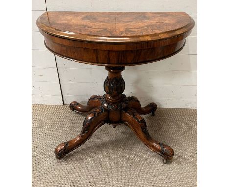 A Demi Lune walnut card table on scrolling supports (72cm x 94cm x 84cm)