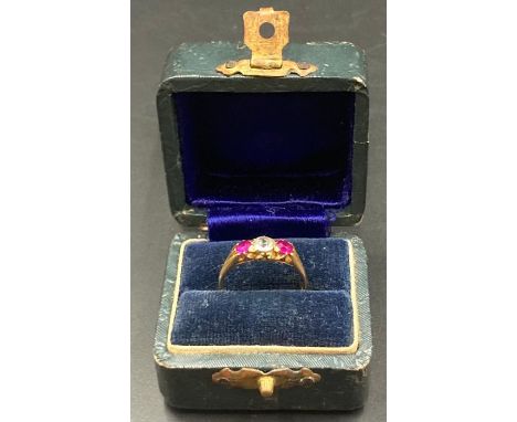 A 22ct gold ring with central diamond and two ruby side stones.