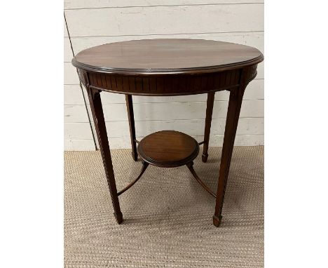 A mahogany centre table with reeded legs and raised shelf under (H72cm Dia70cm)